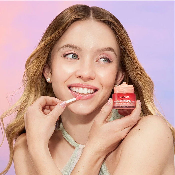 Sydney Sweeney posing with Laneige lip sleeping mask berry